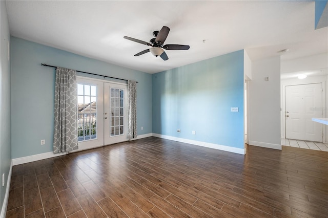 spare room featuring dark hardwood / wood-style floors, ceiling fan, and french doors