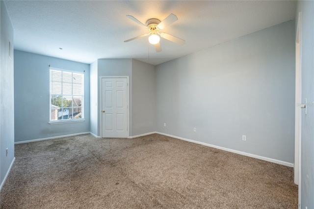 carpeted empty room with a textured ceiling and ceiling fan