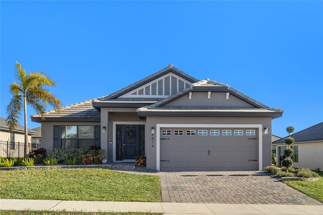 view of front of property featuring a garage and a front lawn