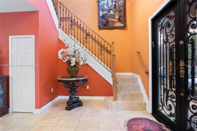 foyer entrance with french doors and light tile patterned flooring