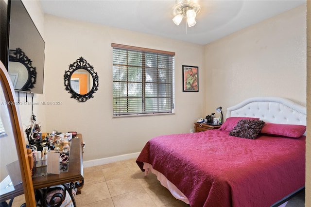 tiled bedroom featuring ceiling fan