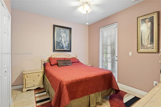 bedroom with ceiling fan, a closet, and light tile patterned floors