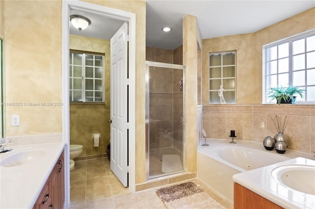 full bathroom with independent shower and bath, tile patterned flooring, vanity, and toilet