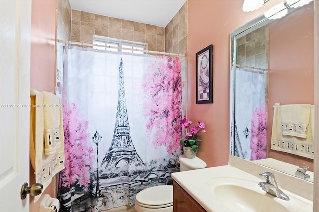 bathroom featuring toilet, walk in shower, and vanity