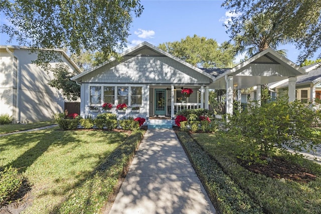 bungalow-style house with covered porch and a front lawn