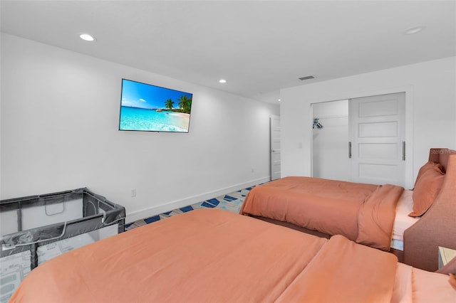 carpeted bedroom with a closet