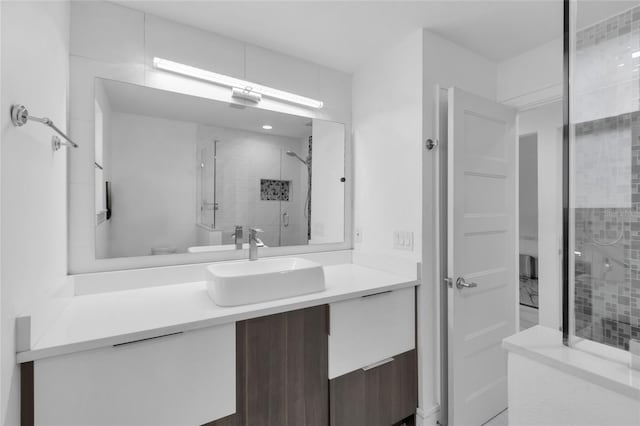 bathroom with vanity, toilet, and a shower with shower door