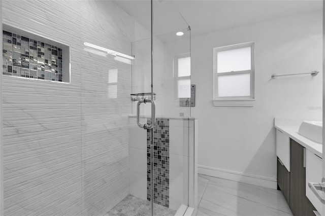 bathroom with vanity and a shower with door