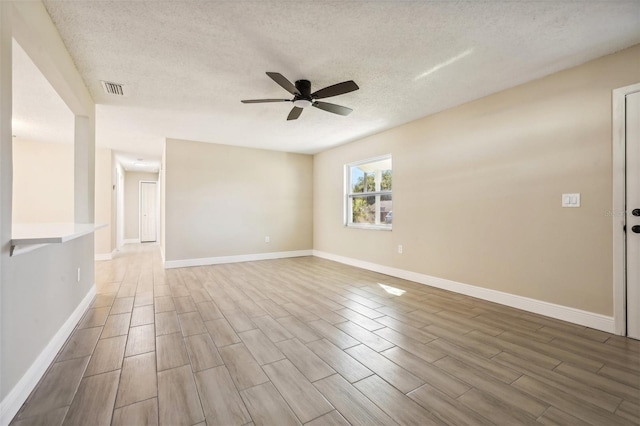 unfurnished room featuring hardwood / wood-style floors, a textured ceiling, and ceiling fan