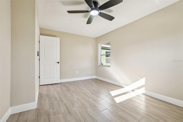 unfurnished room with ceiling fan, light hardwood / wood-style floors, and a textured ceiling