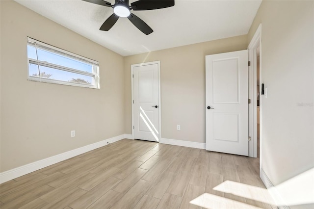 unfurnished bedroom with ceiling fan and light hardwood / wood-style flooring