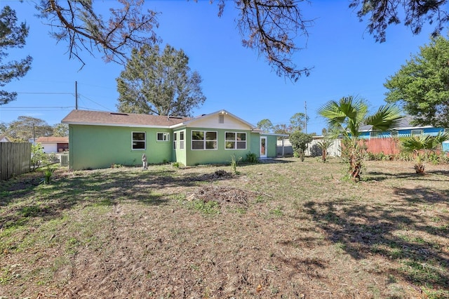 rear view of house featuring a lawn