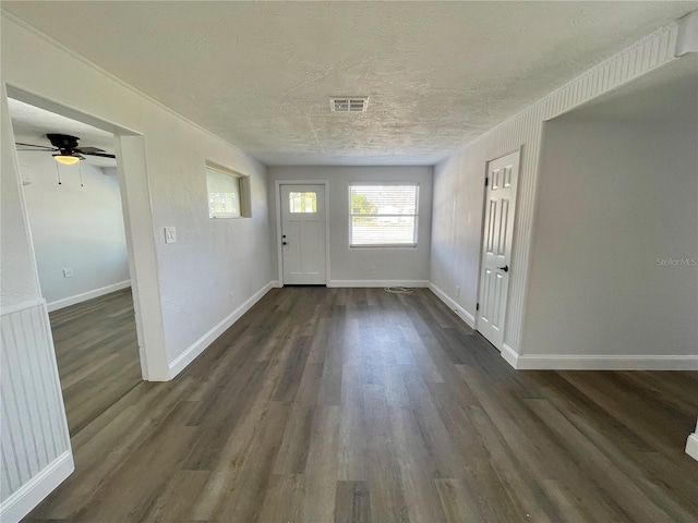 foyer entrance featuring a textured ceiling, dark hardwood / wood-style floors, and ceiling fan