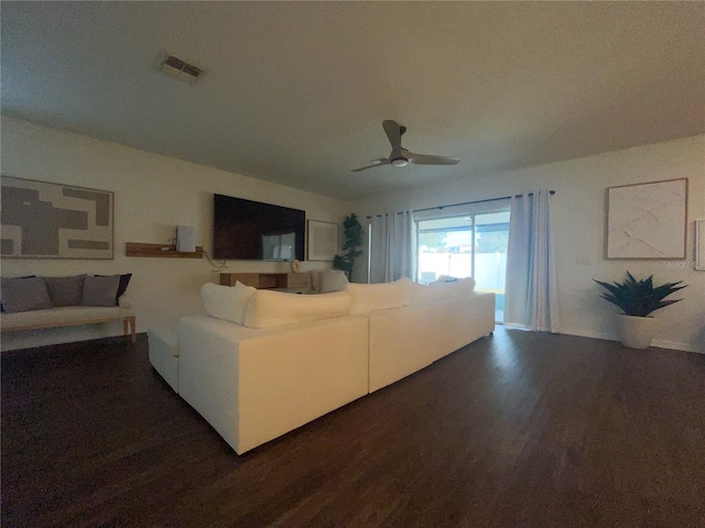 living room with dark hardwood / wood-style floors and ceiling fan