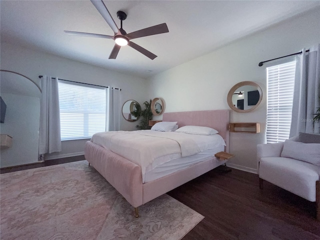 bedroom with ceiling fan and dark wood-type flooring