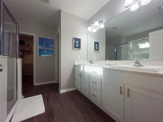 bathroom featuring vanity, wood-type flooring, and walk in shower