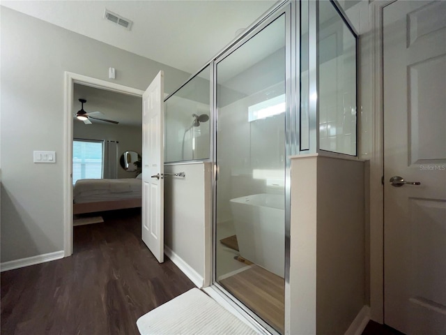 bathroom featuring hardwood / wood-style flooring, ceiling fan, and plus walk in shower