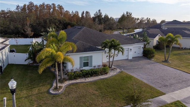 view of front of property with a front yard and a garage