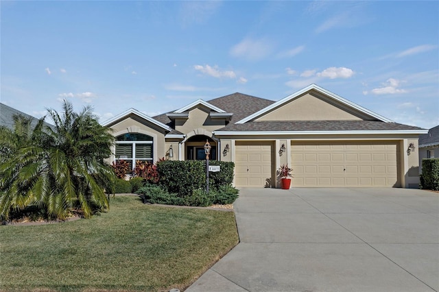 view of front of property featuring a front yard and a garage