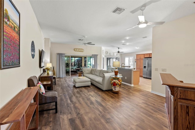 living room featuring ceiling fan and wood-type flooring