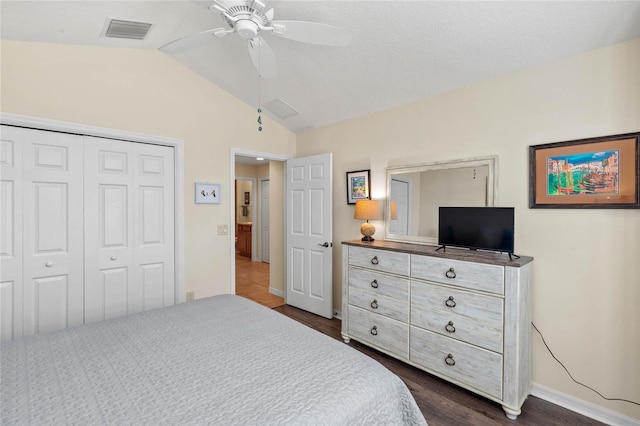 bedroom with lofted ceiling, dark wood-type flooring, ceiling fan, and a closet