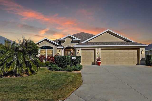 view of front of house featuring a garage and a yard