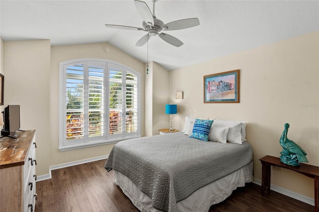 bedroom with dark wood-type flooring, vaulted ceiling, and ceiling fan