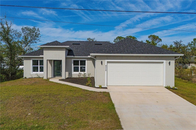 single story home with a garage and a front lawn