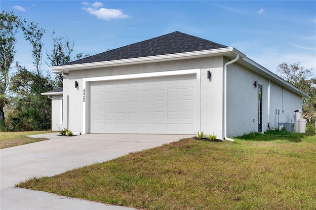 view of side of home featuring a yard and a garage