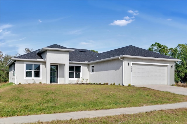 prairie-style home with a front lawn and a garage