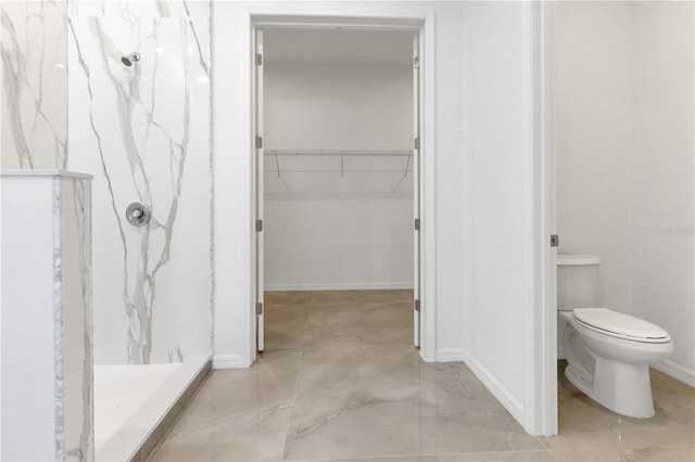 bathroom featuring a shower and toilet