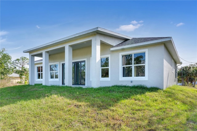 back of property featuring a lawn