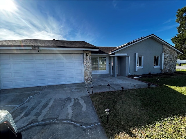 single story home with a garage and a front lawn