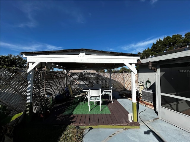 view of dock with a gazebo and a patio