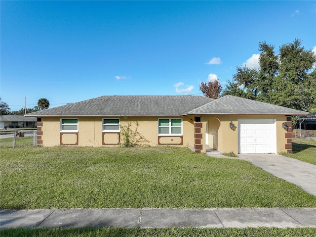 single story home featuring a garage and a front lawn