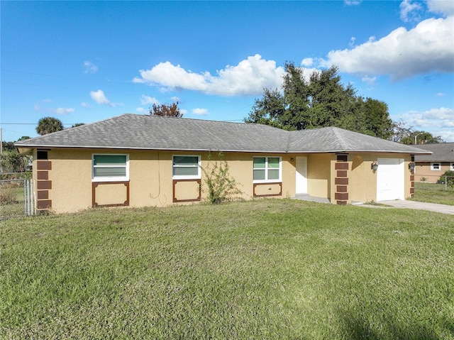 single story home featuring a garage and a front lawn