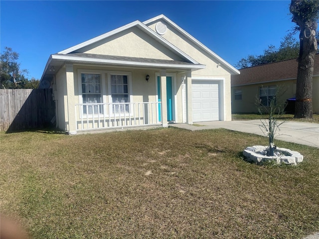 view of front of home with a front lawn, covered porch, and a garage