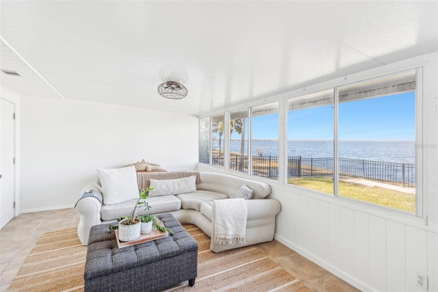 sunroom / solarium with a water view