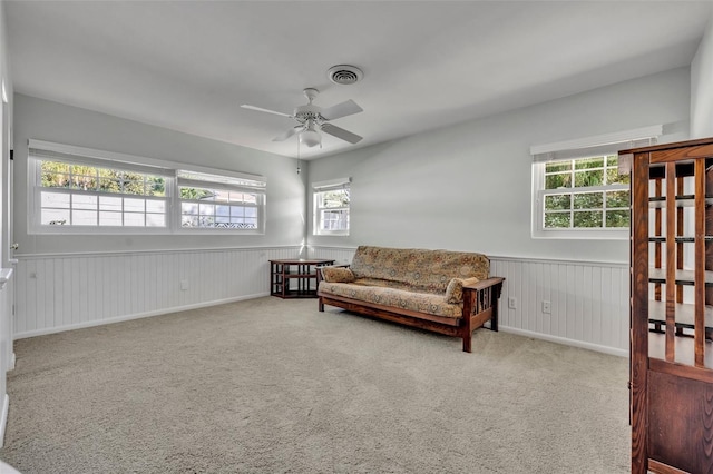 sitting room with carpet, plenty of natural light, and ceiling fan