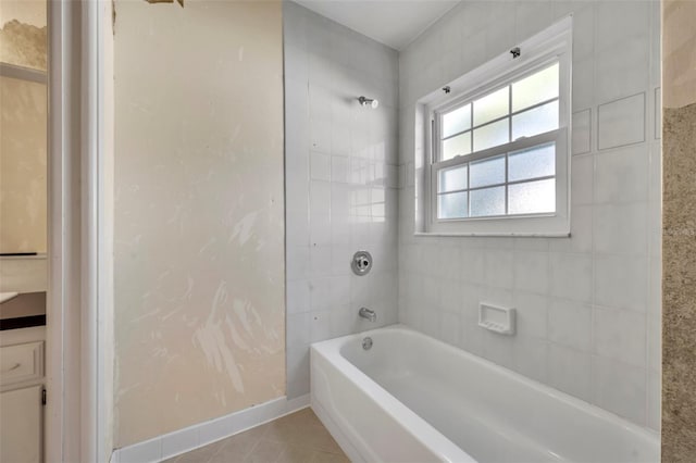 bathroom with tile patterned floors, vanity, and tiled shower / bath combo