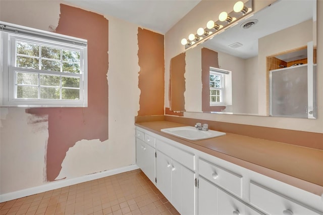 bathroom with tile patterned floors, plenty of natural light, and vanity