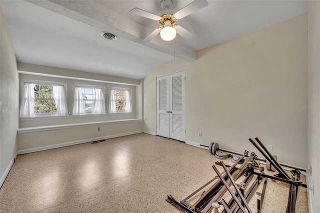 workout room featuring ceiling fan and vaulted ceiling