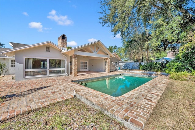 exterior space featuring a fenced in pool and a patio