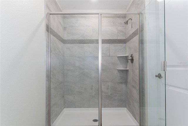 bathroom featuring a shower with door