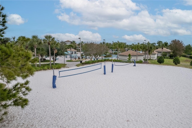 view of property's community featuring a water view and volleyball court