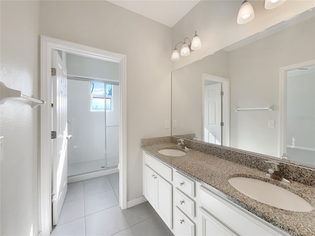 bathroom featuring tile patterned flooring, vanity, and a shower with shower door