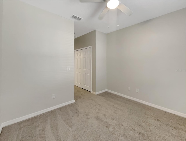 carpeted empty room with ceiling fan