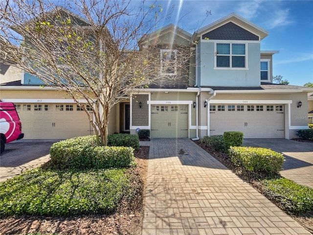 view of property with decorative driveway and stucco siding
