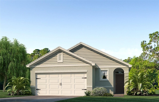 view of front of property with a garage and a front lawn