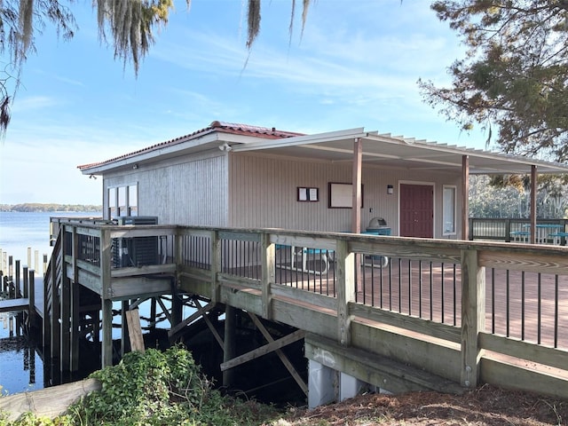 back of house with a deck with water view